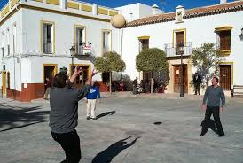 A puréed and simmering carrot soup in a pot with a spoon